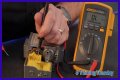 How do you test a Honeywell gas valve with a multimeter?